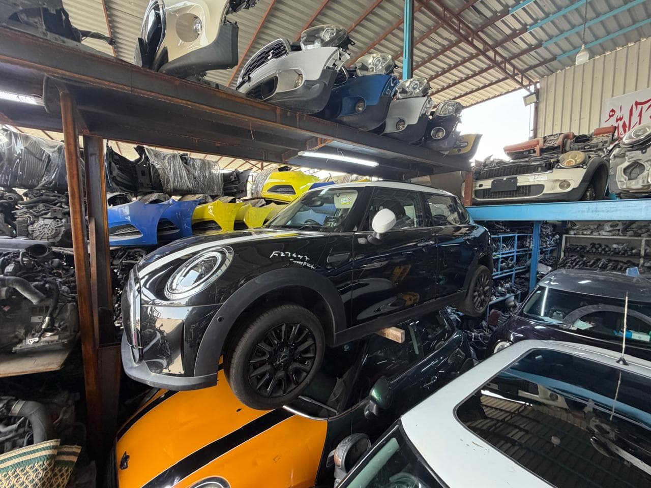 A complete donor MINI stored on the rack among stock